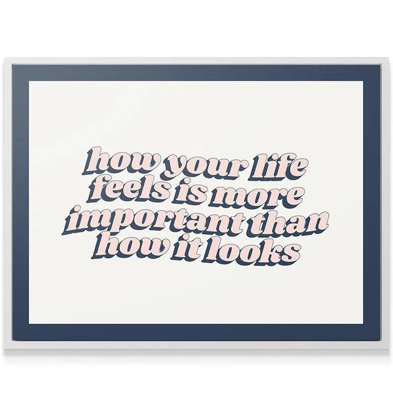 Lifestyle shot of the retro quote print hanging in a bright, modern office space reminding you of the good Life.