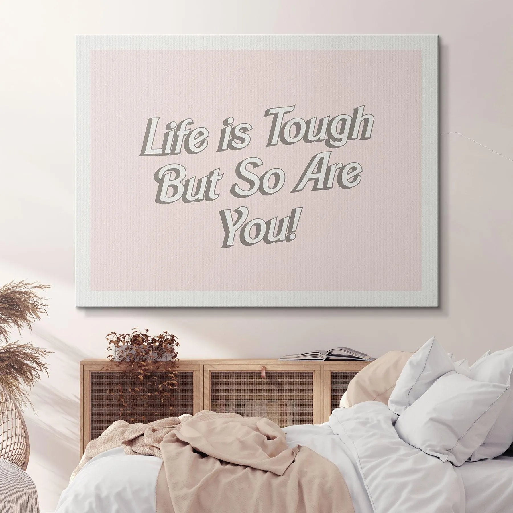 Flat lay presentation of the inspirational quote print titled 'Life is Tough' next to a small, aesthetically pleasing succulent.
