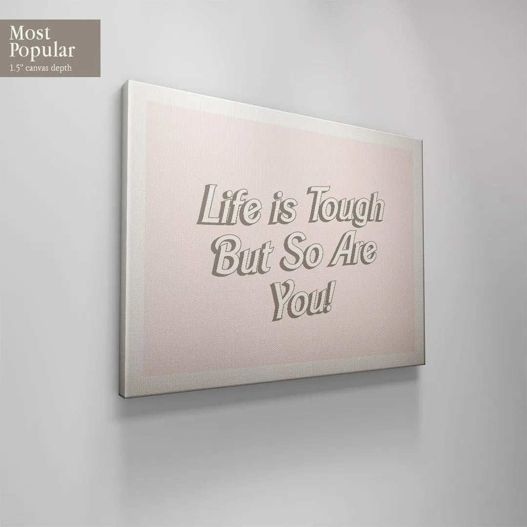 Mockup showing the large size variant of the 'Life is Tough' artwork hanging above a contemporary living room sofa.
