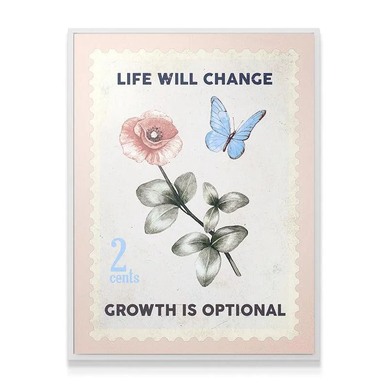 Lifestyle shot of the Life Will Change canvas art hanging above a minimalist wooden desk setup.