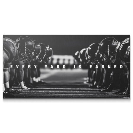 Close-up view of crouched linemen helmets at the line of scrimmage with text 'Linemen - Every Yard Is Earned'.