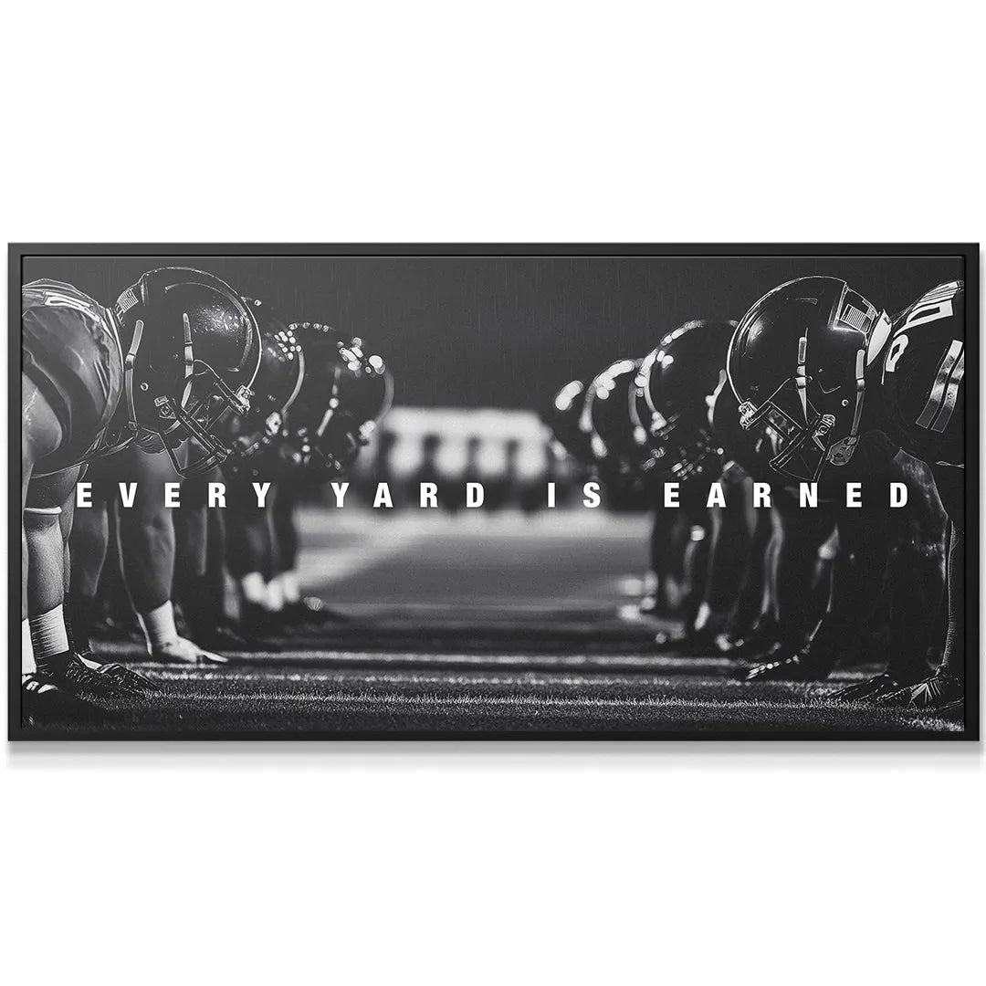 Black and white panoramic canvas wall art showing opposing football teams ready to snap: 'Linemen - Every Yard Is Earned'.