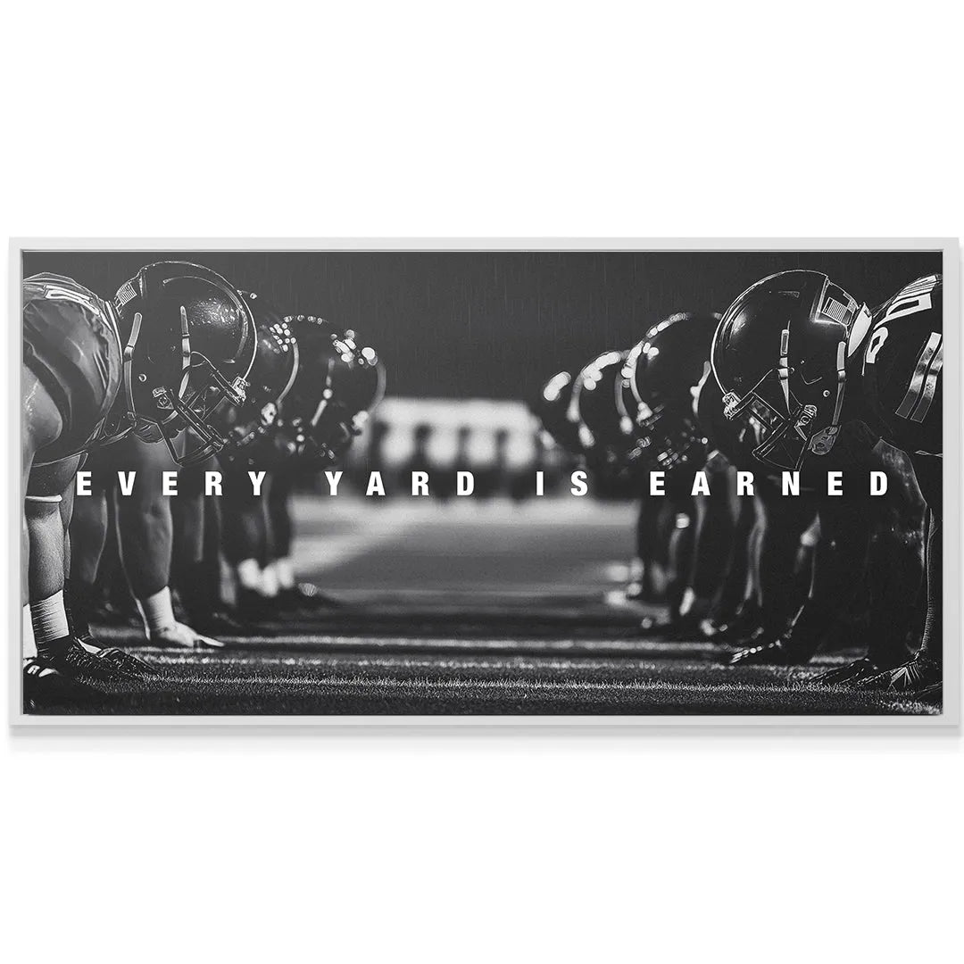 Low-angle shot emphasizing the turf texture and cleated shoes under the banner 'Linemen - Every Yard Is Earned'.