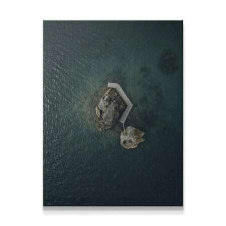 Overhead view of the 'Lonely Rock' canvas print showing deep teal water texture.