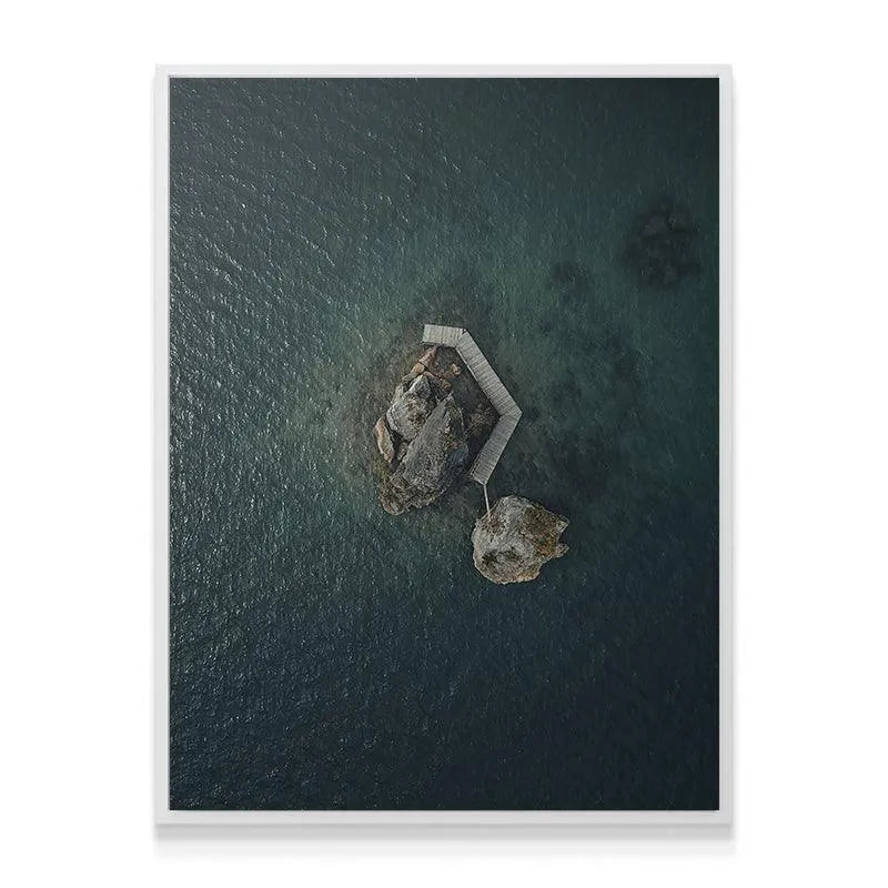 High-contrast aerial photograph of the 'Lonely Rock' formation, emphasizing stone texture.