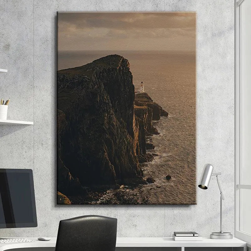 Wide perspective of the immense sea and imposing cliffs framing the tiny Lonesome Lighthouse structure.