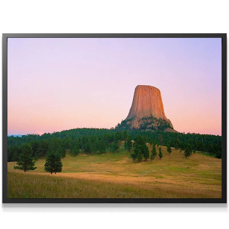 Horizontal orientation fine art print of Magic Hour At The Devils Tower highlighting the dense forested base.