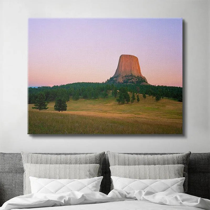 Atmospheric shot of Magic Hour At The Devils Tower emphasizing the lavender and warm orange color palette.