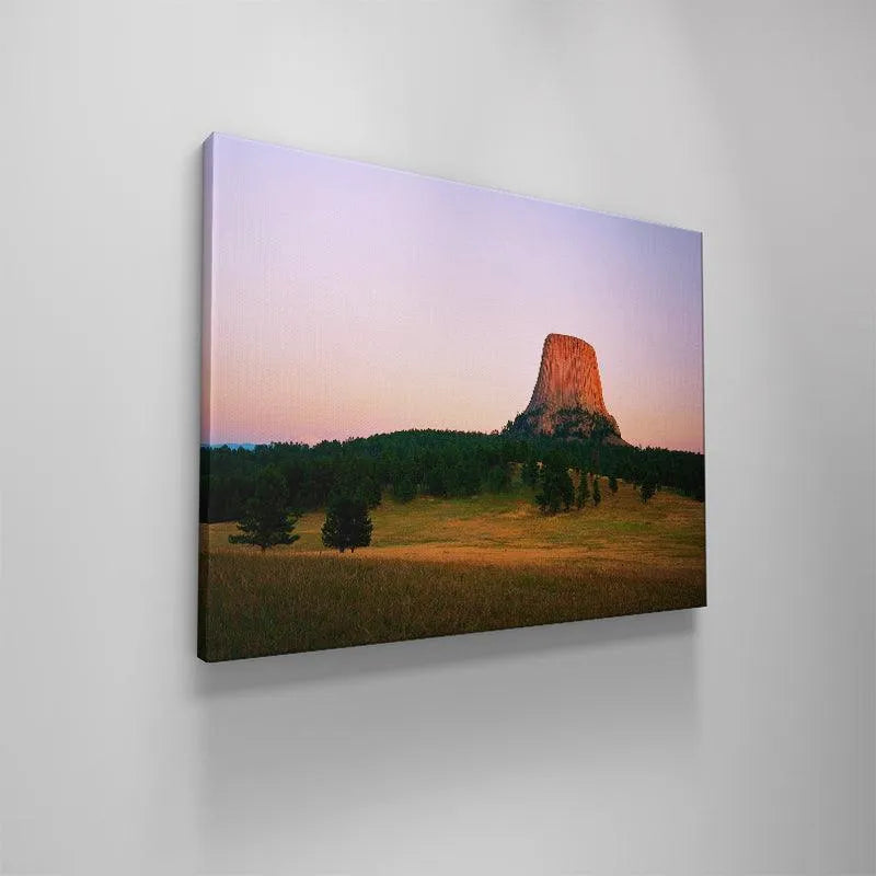 High-resolution photograph depicting the magical twilight light falling on the towering structure of Magic Hour At The Devils Tower.