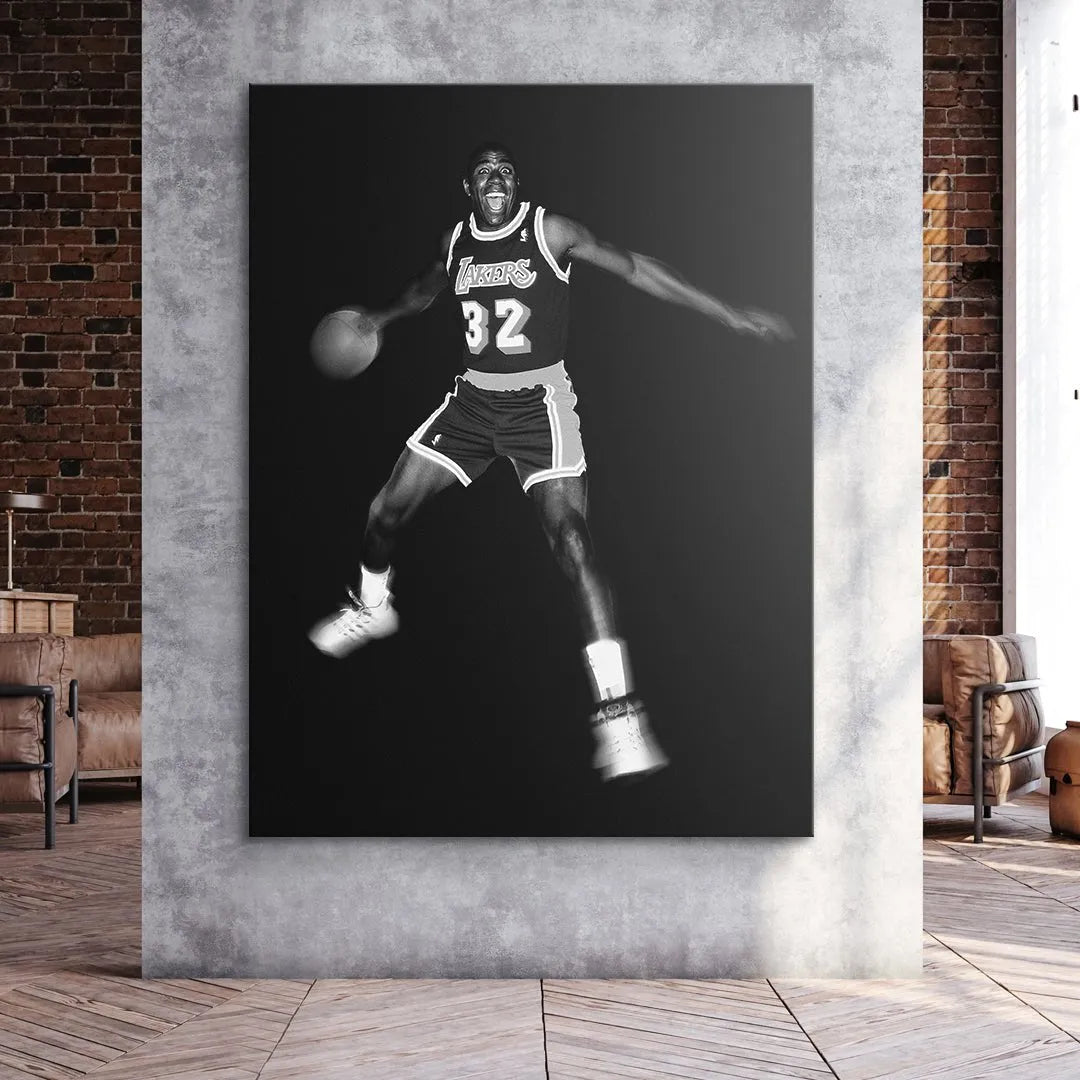 Profile view of the basketball held by Magic Johnson - It's Magic against the dark background.