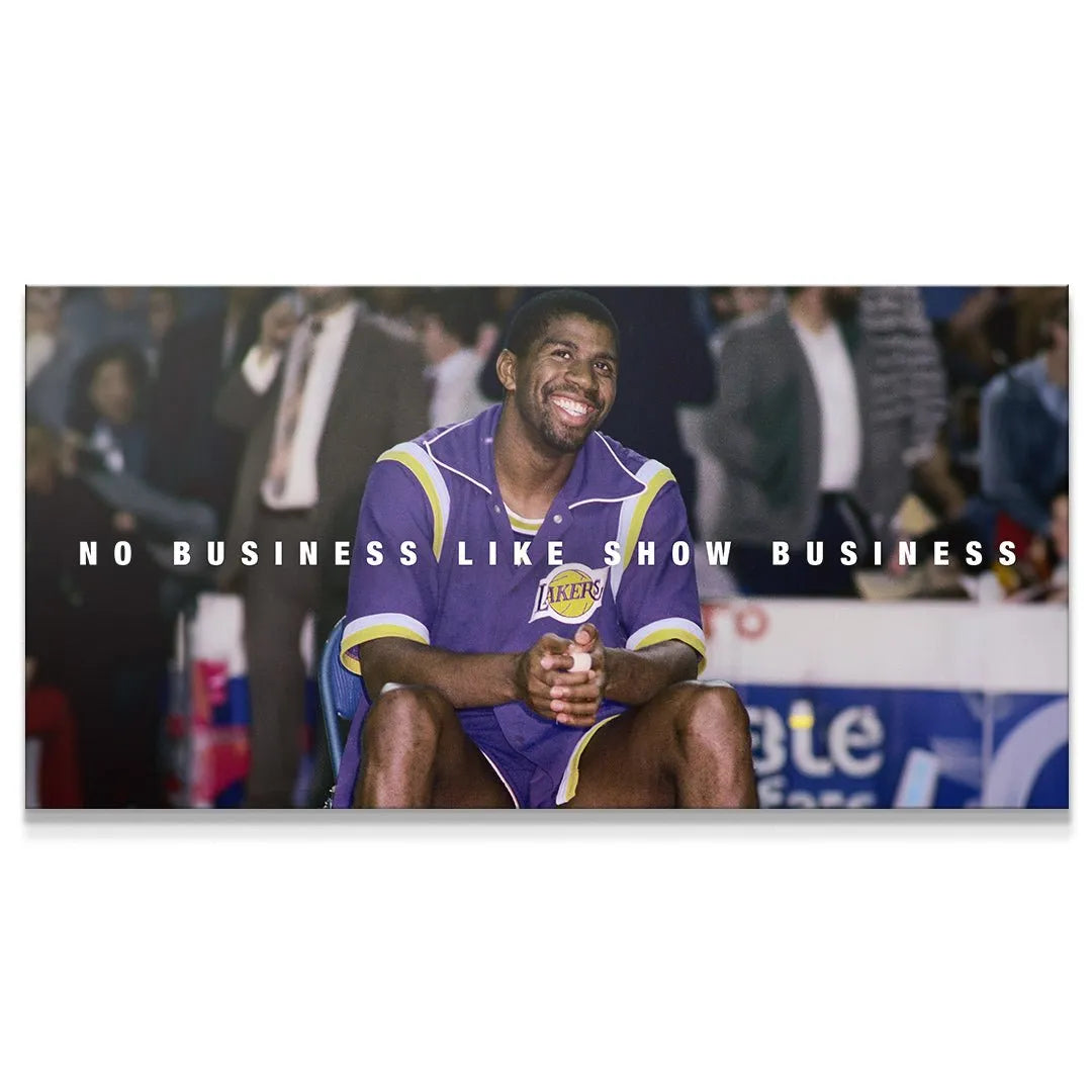 Full panoramic view of Magic Johnson - Show Business courtside smiling in Laker uniform.