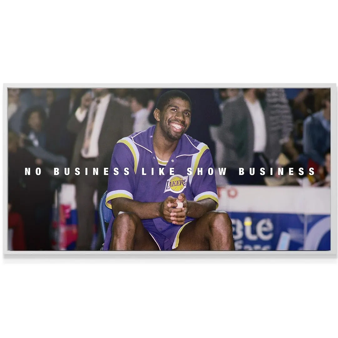 Horizontal orientation depicting the full scene of Magic Johnson - Show Business on the bench.