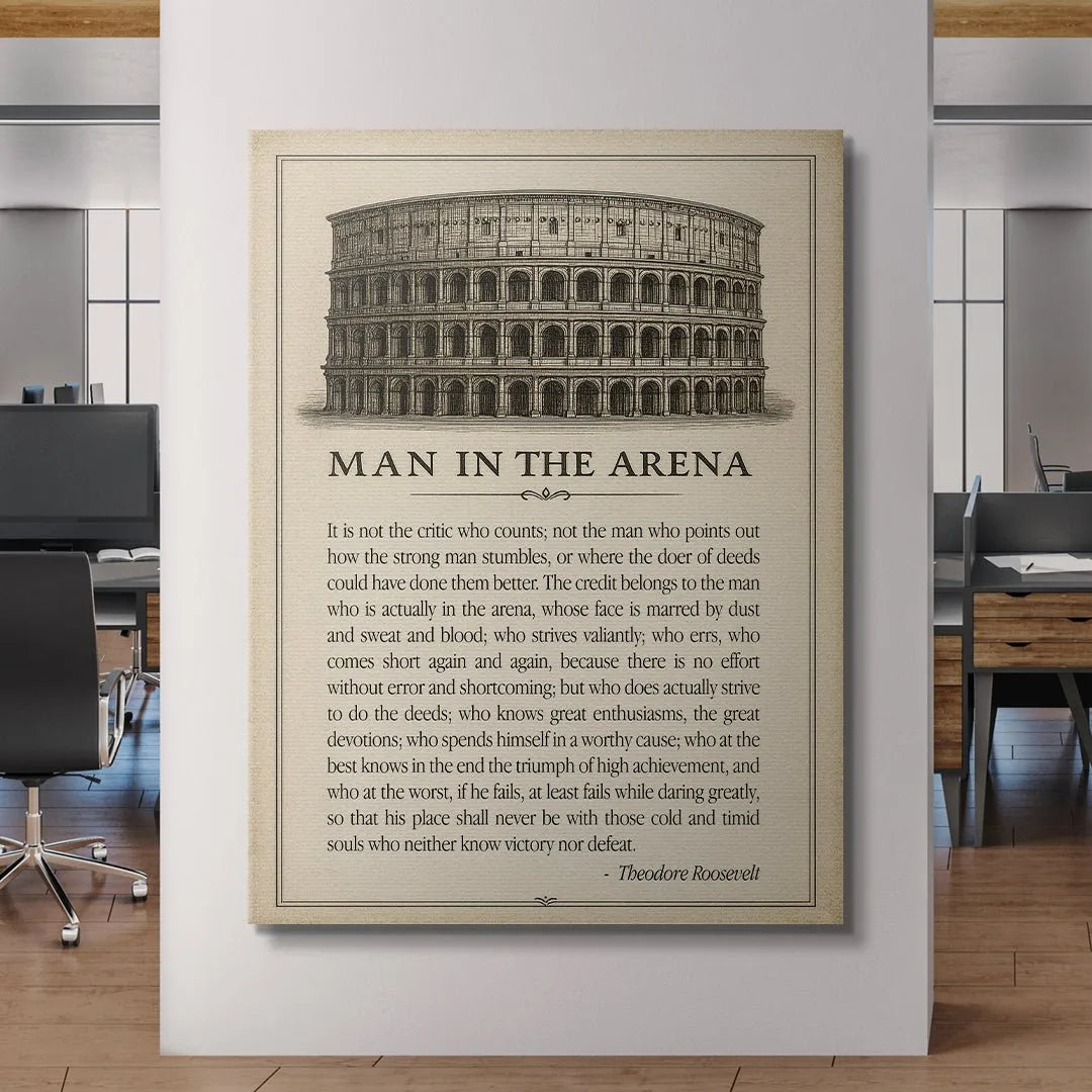 Lifestyle shot: framed 'Man In the Arena - Type' poster hanging above a desk in a professional home office setting.