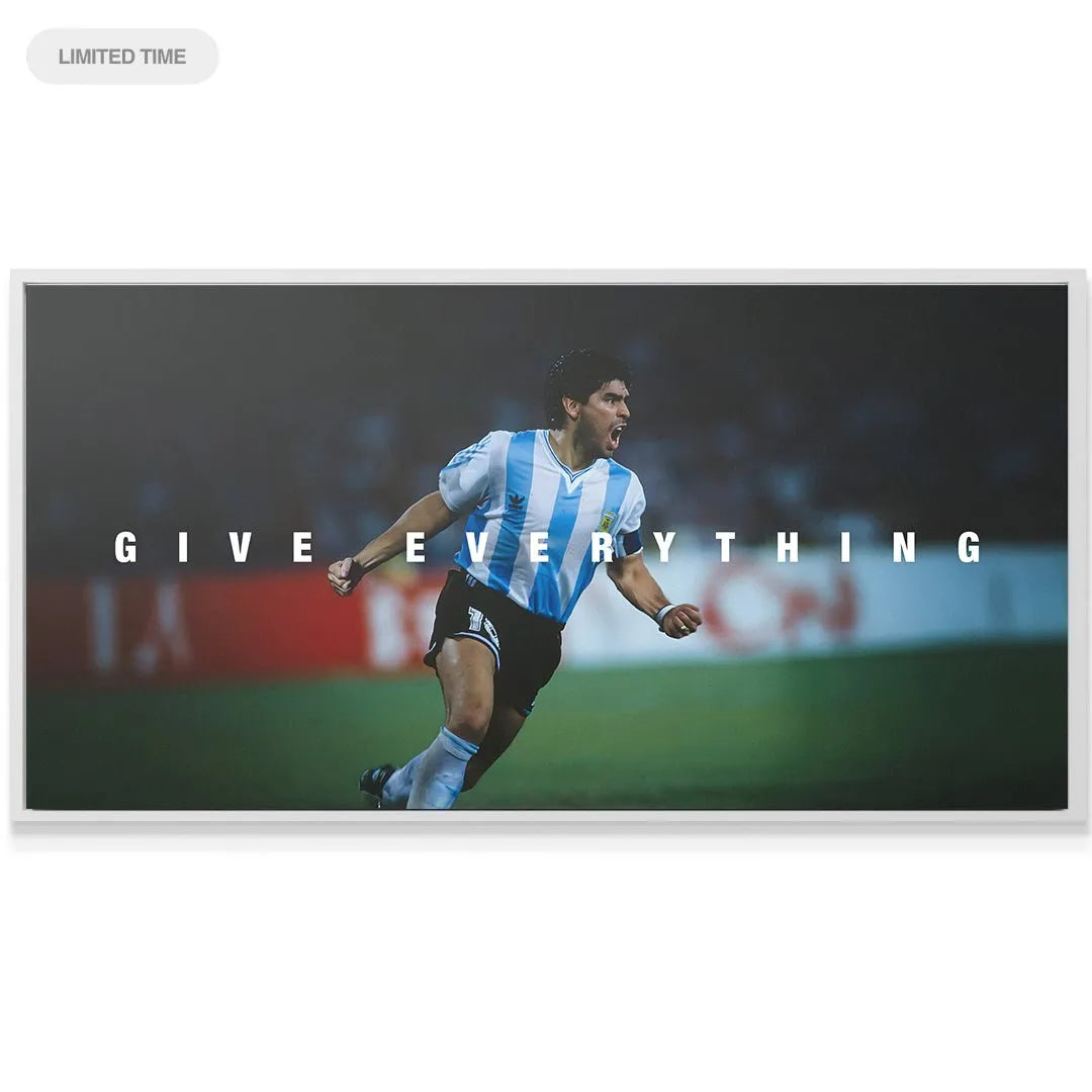Wide-angle shot showing the contrast between the dark stadium background and the vibrant 'Maradona - Give Everything - 2' text overlay.
