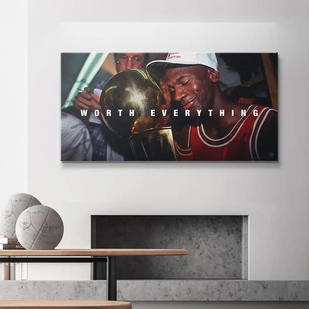 Framed artwork of a basketball player holding a trophy with 'Worth Everything' text in a modern room.
