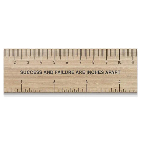 Full overhead view of the wooden 'Measure Of Success' ruler on a clean white background.