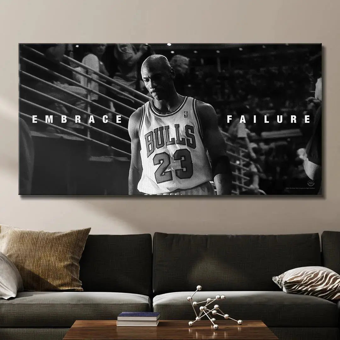 Lifestyle presentation of the Michael Jordan - Embrace Failure wall art hanging prominently above a modern office desk.
