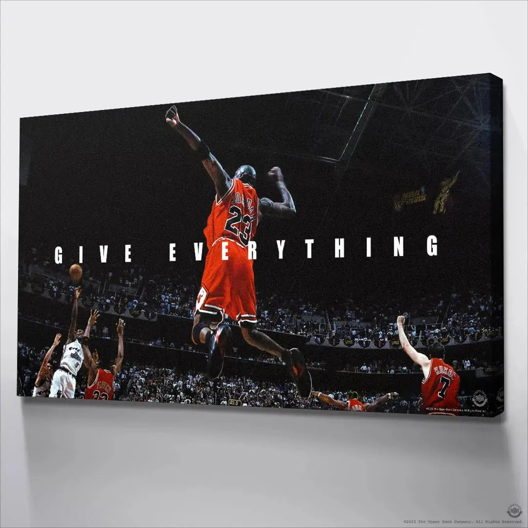 Motivational 'GIVE EVERYTHING' text overlaying the soaring figure of Michael Jordan, defining the image's theme.