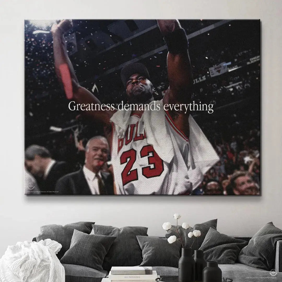 Low-angle perspective emphasizing the triumph and dedication represented by Michael Jordan - Greatness Demands Everything.
