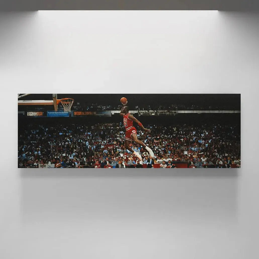 Lifestyle shot featuring the framed Michael Jordan - Mid Flight hanging proudly in a collector's organized sports den.
