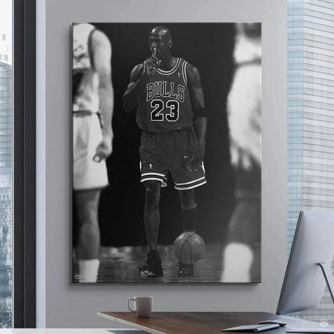 Lower angle detailing the basketball at Michael Jordan's feet and the sleek black sneakers featured in 'Michael Jordan - Quiet the Competition'.