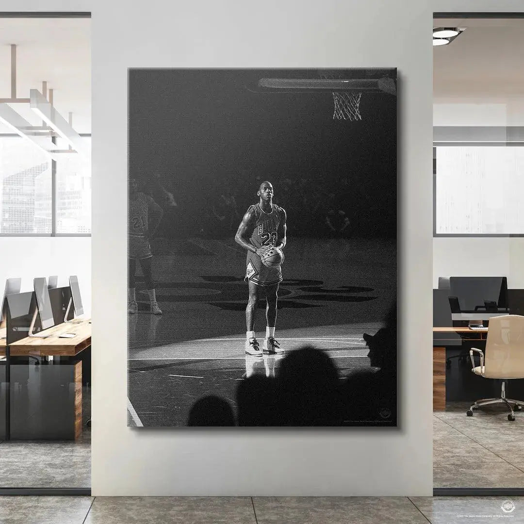 Low angle perspective emphasizing the height and singular focus of Michael Jordan - Spotlight readying for a shot.