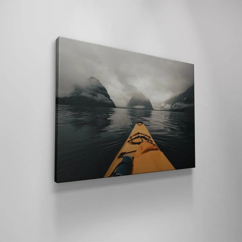 Yellow kayak bow slicing through dark, reflective water, highlighting the smooth action of Milford Paddles