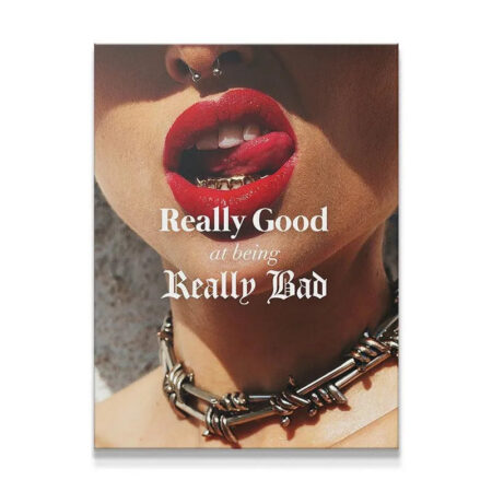 Extreme close-up of red lips and gold grills emphasizing the text "Really Good At Being Really Bad."