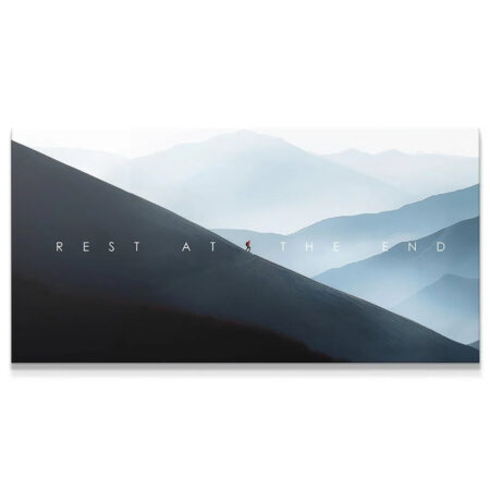 Panoramic landscape art showing a lone hiker on a steep dark slope with text 'Rest At The End'.