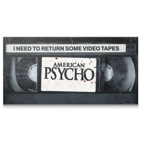 Close-up of the VHS label texture displaying 'American Psycho' and remembering to Return Video Tapes.