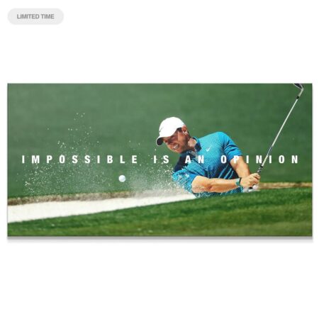 Close-up of Rory McIlroy smiling during an aggressive bunker recovery shot: Rory - Impossible Is An Opinion.