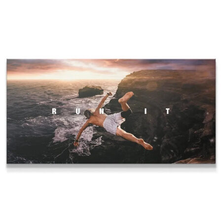 Man diving from cliff edge into ocean at sunset,embodying the spirit to Run It.