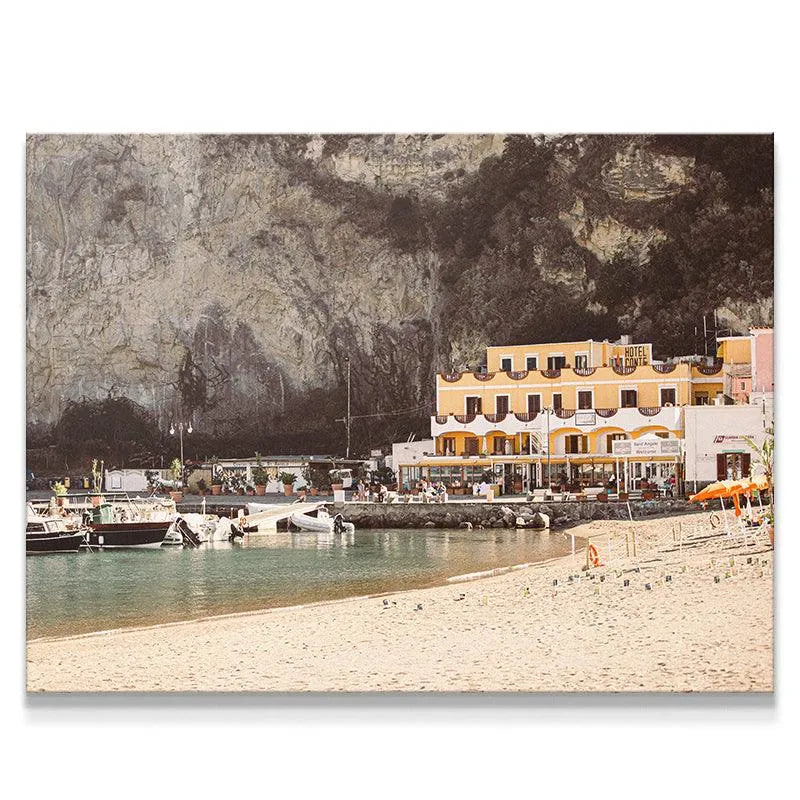 Panoramic view of Sant' Angelo harbor featuring the golden beach and towering cliff.