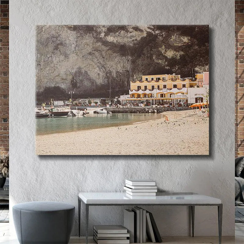 Texture focus on the massive, rugged cliff face rising dramatically behind Sant' Angelo town.