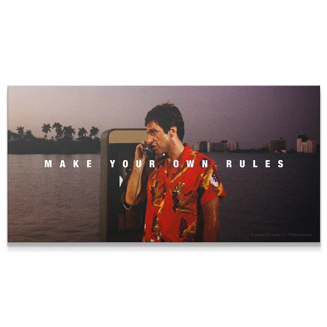 Cinematic wide shot perspective: Tony Montana in red shirt on payphone, showcasing the full 'Scarface - Make Your Own Rules' text overlay.
