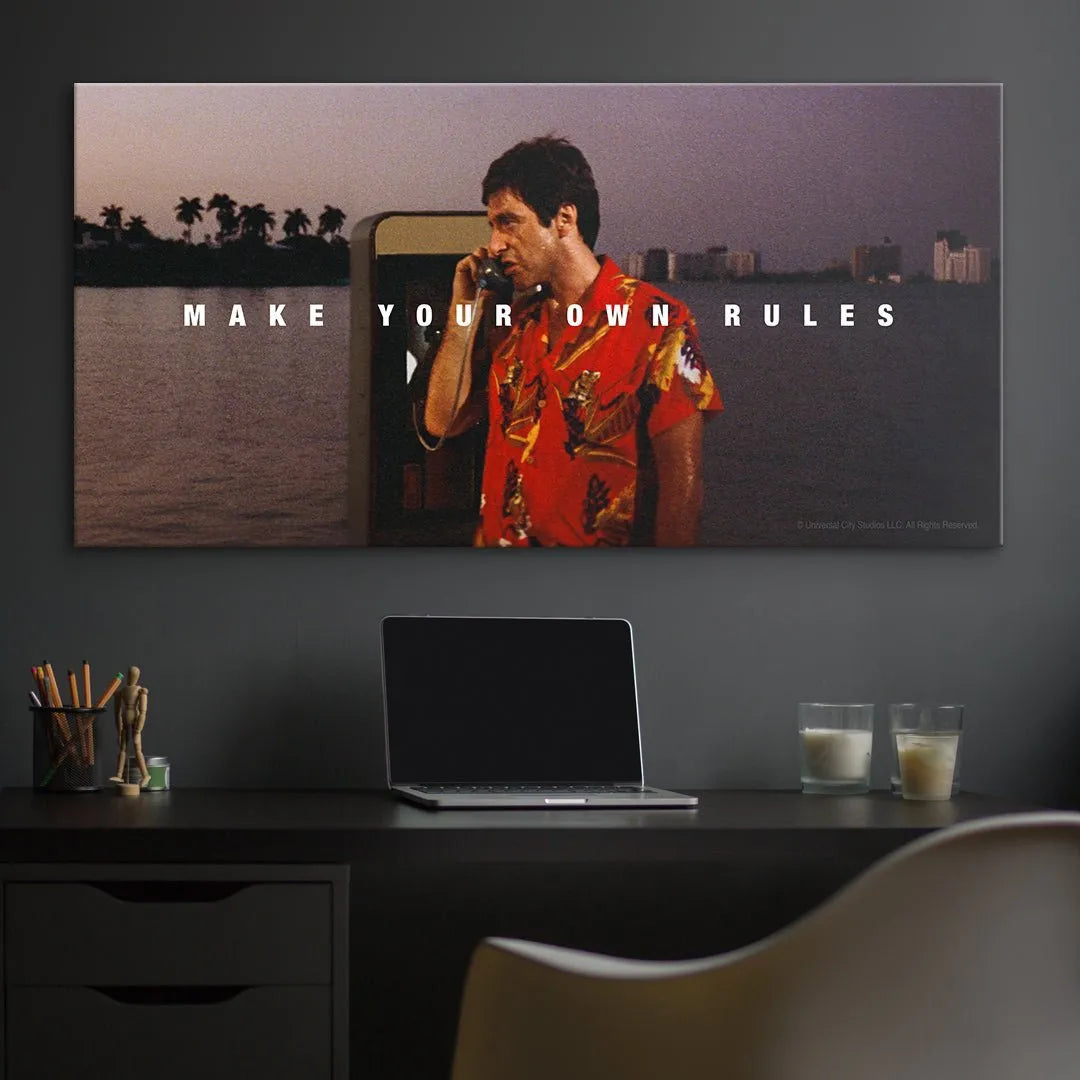 Background focus: Miami skyline and palm trees blurred behind the payphone, framing the theme of 'Scarface - Make Your Own Rules'.