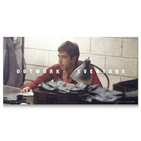 Intense close-up of Tony Montana smoking a cigar/cigarette, featured in the official Scarface - Outwork Everyone cinematic artwork.