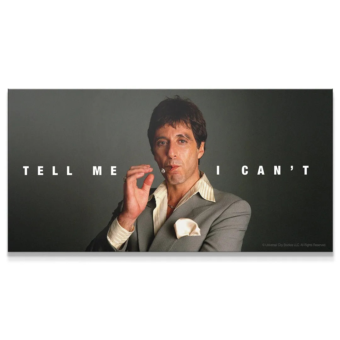 Close-up of Tony Montana smoking, featuring the bold quote 'Scarface - Tell Me I Can't' across the background.