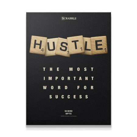 Close-up view of the textured wooden Scrabble - Hustle tiles on a matte black background.