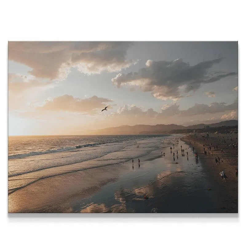Wide horizontal view of a crowded beach at sunset, embodying tranquil Seaside Moments.