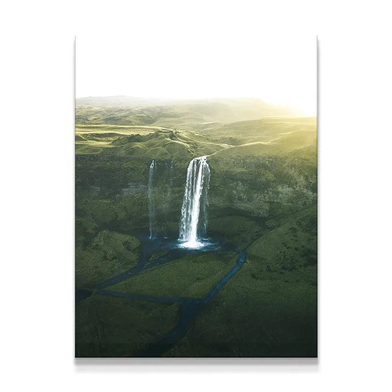 Seljalandsfoss waterfall wide shot bathed in ethereal golden hour sunlight over vibrant green fields.