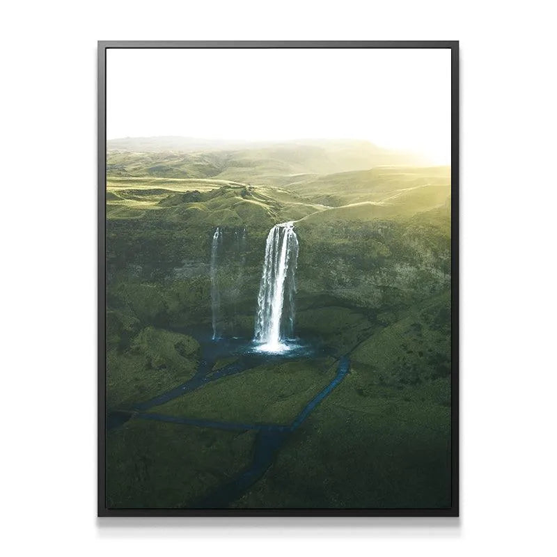 Vertical composition of Seljalandsfoss showing the full height of the powerful water cascade and surrounding mossy cliffs.