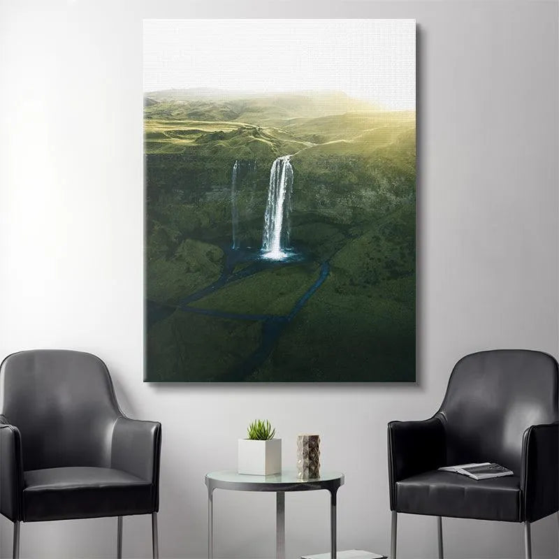 Aerial perspective showing the river flowing away from Seljalandsfoss through the dark green Icelandic valley.