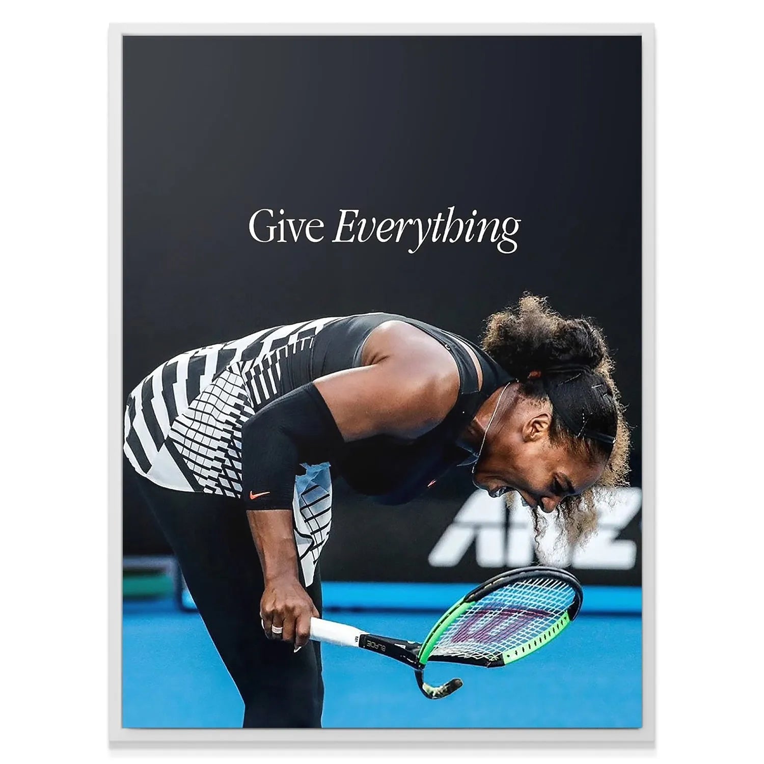 Wide shot of Serena bent over the tennis court, holding the racket, featured in 'Serena - Give Everything' inspirational print.
