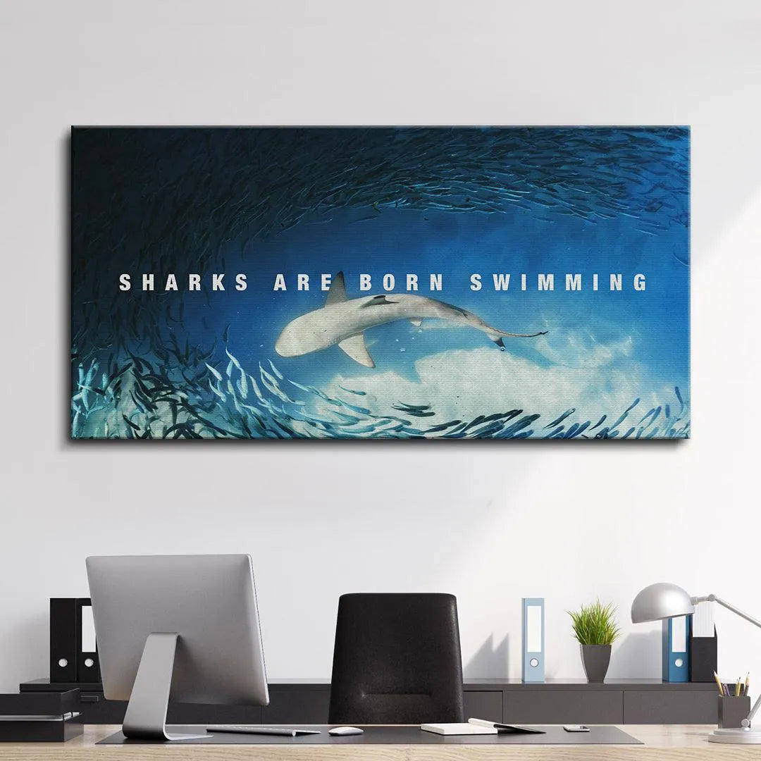 Deep ocean blue palette of the canvas print showcasing the phrase 'Sharks Are Born Swimming' as a centerpiece.