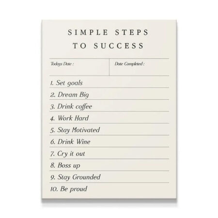 Overhead studio shot of the creamy white "Simple Steps To Success" motivational checklist notepad.