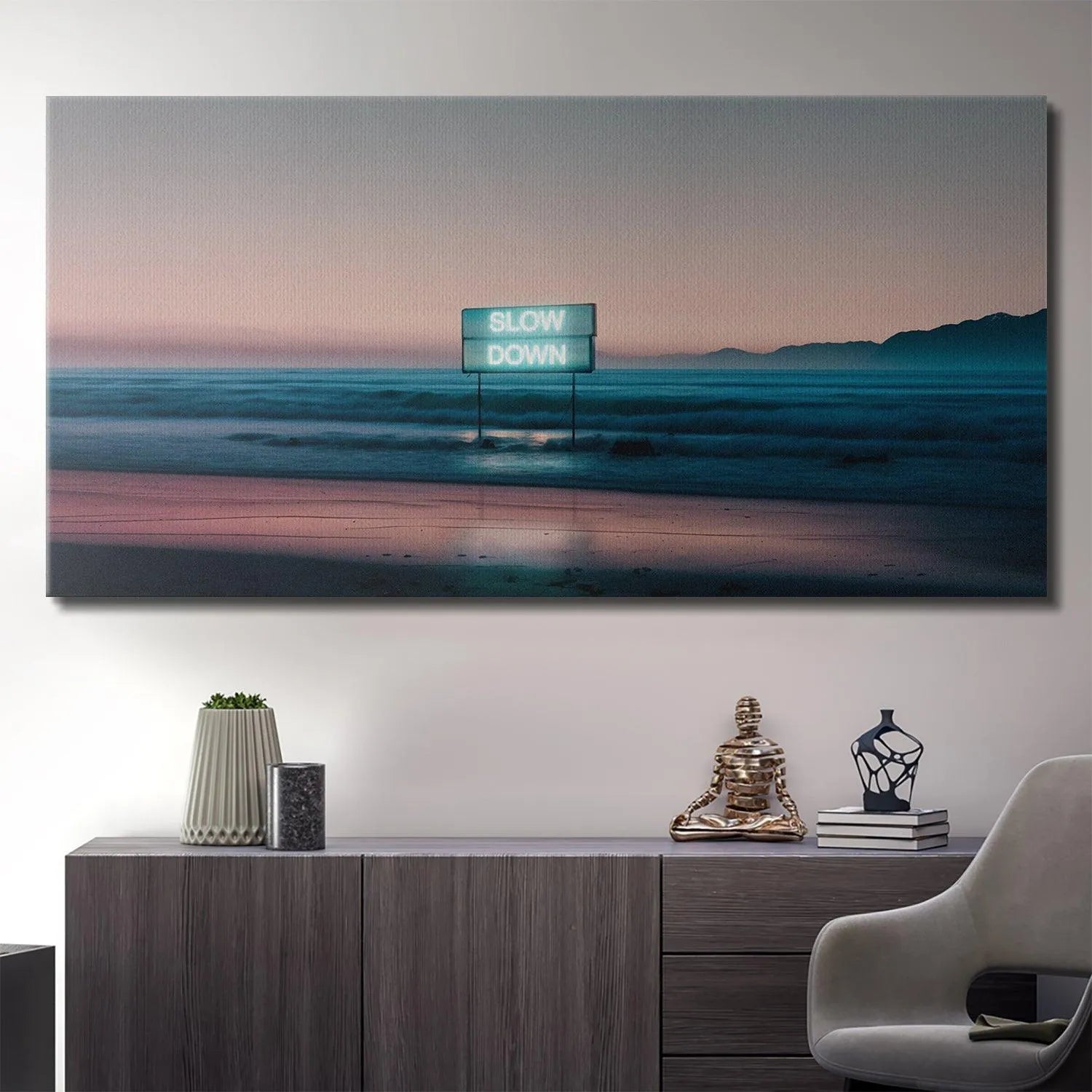 Lifestyle view showing the horizontal 'Slow Down' art displayed above a modern, minimalist living room sofa.