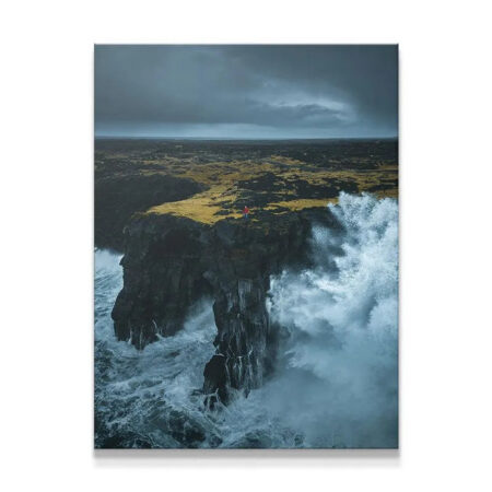Dramatic Solitude canvas print showing huge white waves crashing on a black sea arch.