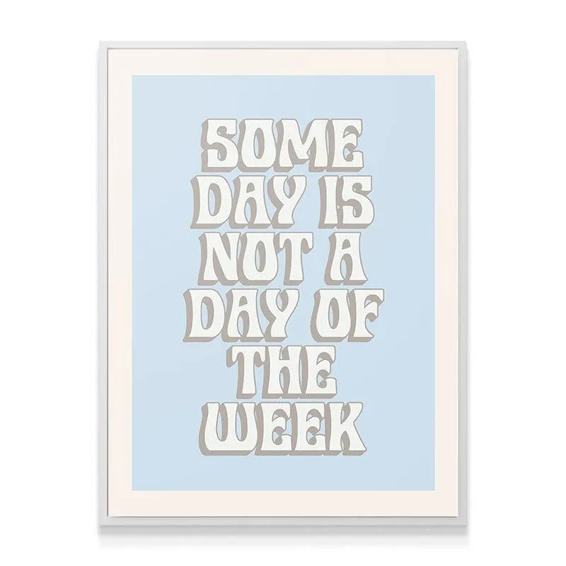 Lifestyle image of the motivational print hanging above a desk in a modern home office setting, encouraging action now, not Some Day