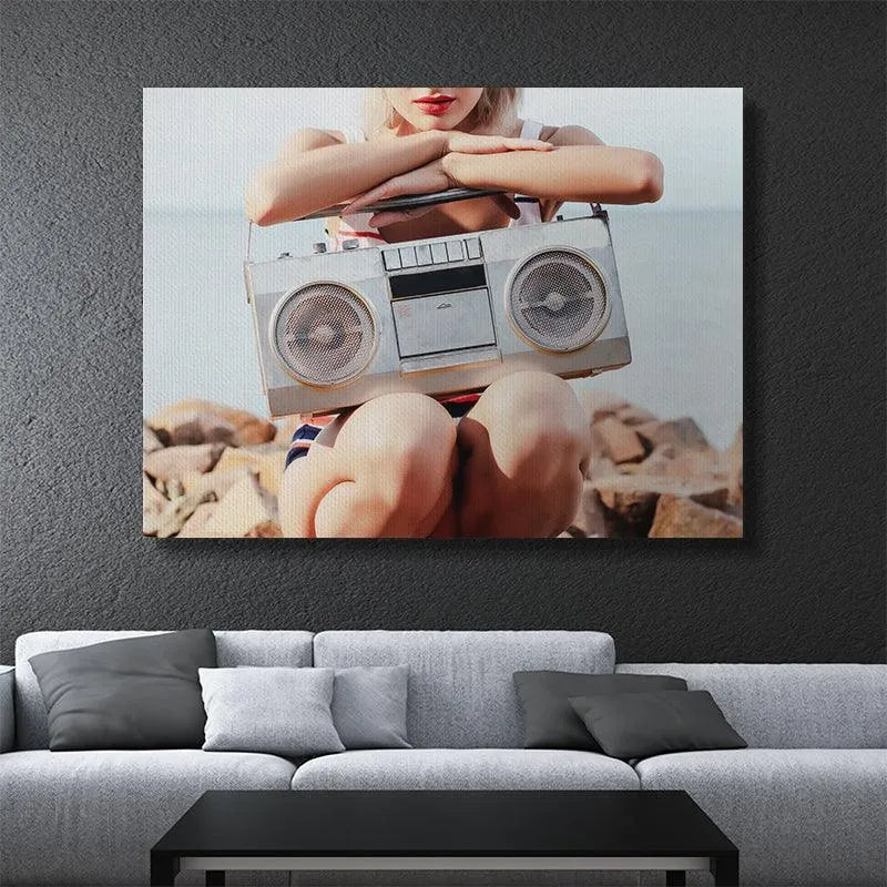Stylish subject resting on rocks with a vintage cassette player, embodying the relaxed lifestyle of Speaker Duty.